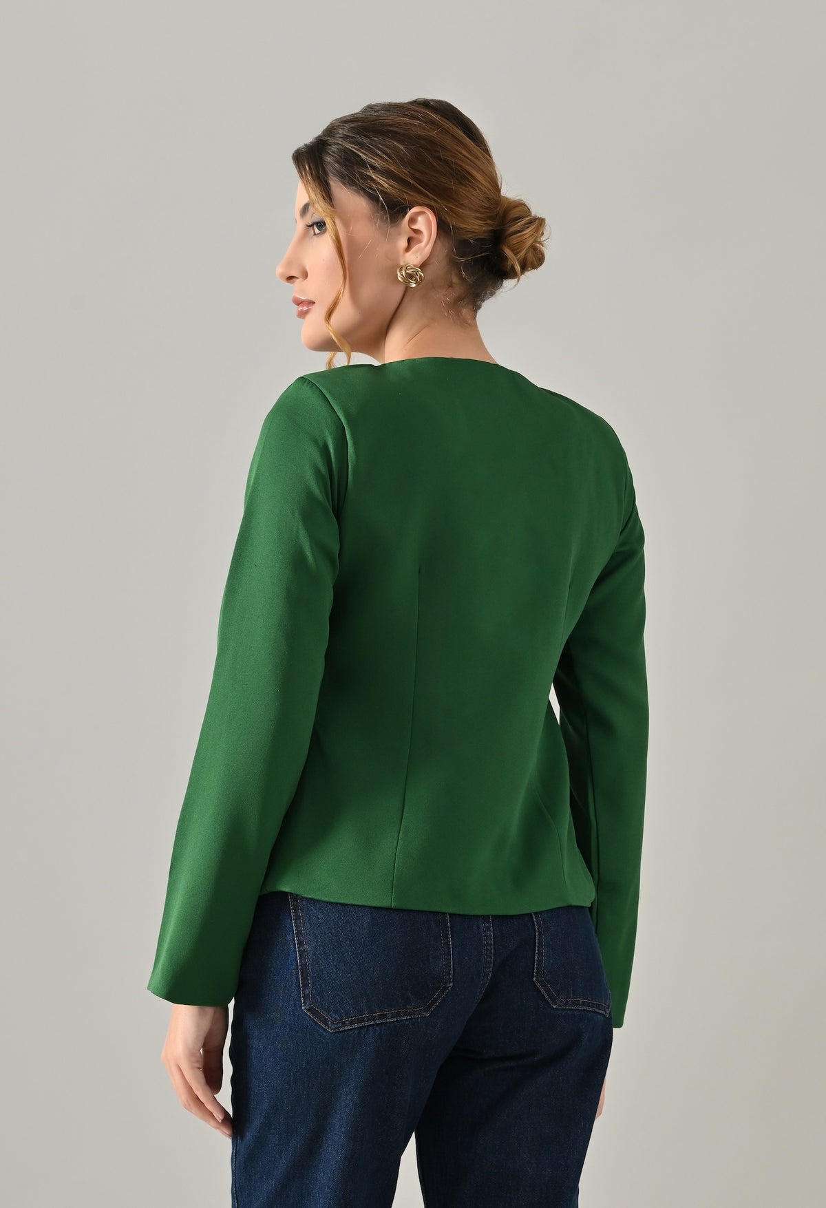 Green coat with bold golden buttons
